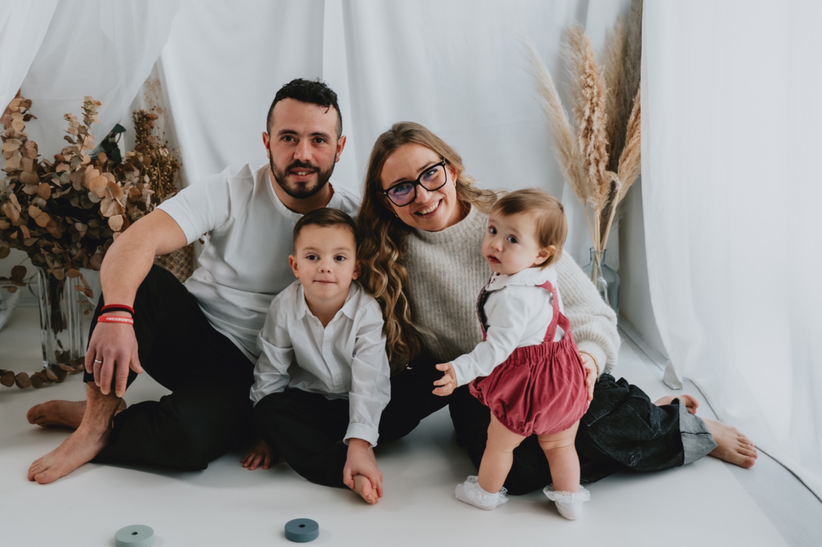 Famiglia seduta a terra con i due figli, prima della torta